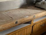 a wooden counter with a machine on it in a kitchen