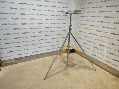 a camera on a tripod in front of a wall