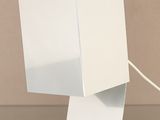 a white lamp that is on top of a table