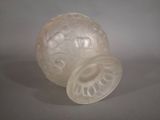 a glass ball with a lid sitting on a table