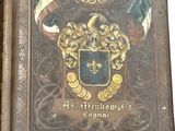 someone is holding a book with a picture of a coat of arms on it