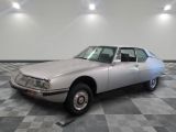 a silver car that is parked on a checkered floor