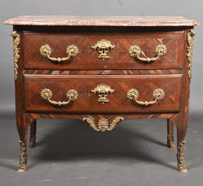 an antique chest of drawers with a marble top