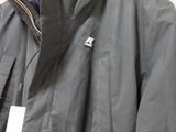 the jacket is black and has a white tag on it