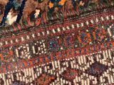 a close up of a rug with a cat laying on top of it