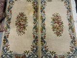 two rugs on a table with a rug on the floor