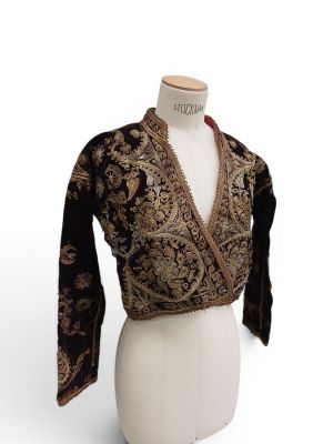a close up of a mannequin wearing a black and gold jacket