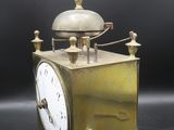 an old brass clock with a bell on top of it