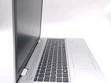 a silver laptop with a black keyboard on a white surface