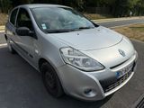 a small silver car parked on the side of the road