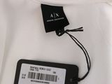 a close up of a white shirt with a tag on it