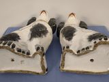 pair of antique porcelain cow feet on blue cloth