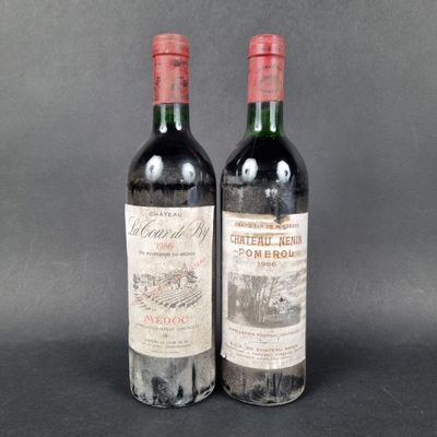 two bottles of red wine sitting next to each other on a table