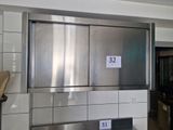 a stainless steel refrigerator in a kitchen with a number on it