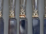 five different types of silverware on display on a table