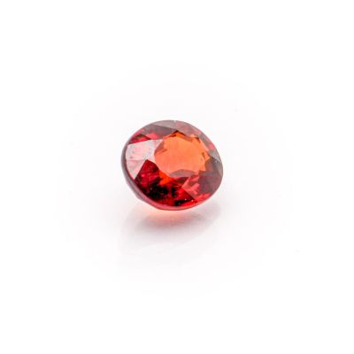 a red garnet stone on a white background