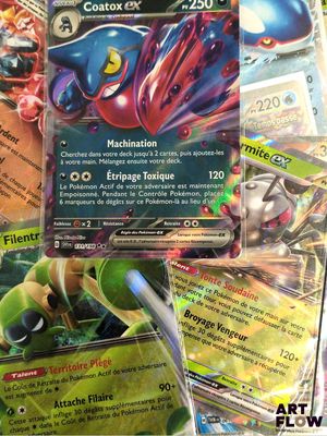 several pokemon cards sitting on top of each other on a table