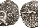 a silver coin with an image of a horse on it