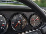 a close up of a car dashboard with gauges and a steering wheel