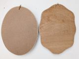 two pieces of cardboard are hanging on a white wall