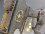 a close up of a metal object with a light bulb in the background