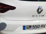 a close up of a white car with a number plate on it