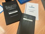 a black folder and a blue folder sitting on a table