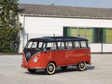 a red and black vw bus parked in front of a white building