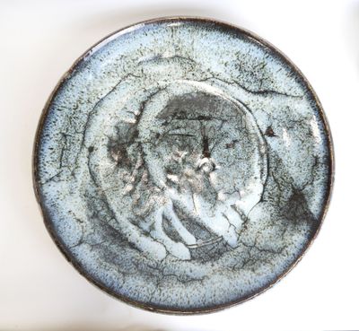 a close up of a plate with a face on it