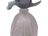 a glass vase with a flower in it on a white background