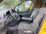 the interior of a yellow van with a steering wheel and dashboard