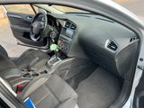 the interior of a car with the door open showing the steering wheel and dashboard