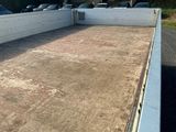 a concrete parking lot with cars parked in the lot