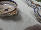 a person that is sitting at a table with a bowl and plate