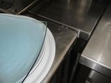 a blue bowl sitting on top of a counter next to a stove