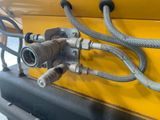 a close up of a hose attached to the side of a yellow truck