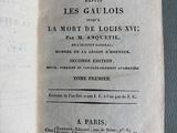 an open book on a table with french writing on it