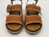 the children ' s sandals are made of leather and have braid straps