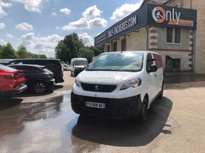 a small white van parked in front of a building