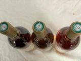 three bottles of wine that are sitting on a table