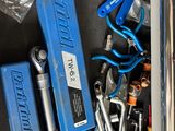a blue tool box filled with tools on a table