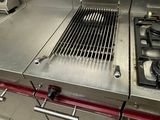 a large stainless steel stove top in a commercial kitchen