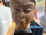 a statue of a woman ' s head sitting on a table