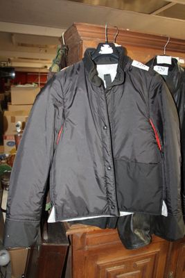 deux vestes suspendues à une étagère en bois dans une pièce