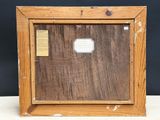 an old wooden picture frame with a label on it