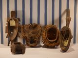 several different types of african masks displayed on a table