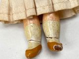 a close up of a doll ' s feet with a dress and boots