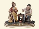 a figurine of a man and a woman sitting on a bench