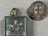 a small silver medal and a small silver medal