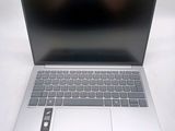 a silver laptop computer sitting on top of a white table